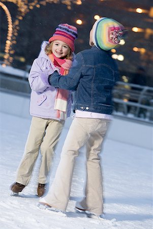family skating - Two girls outdoors in winter smiling Stock Photo - Premium Royalty-Free, Code: 640-01349046