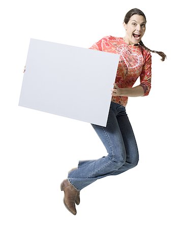 simsearch:640-03257317,k - Portrait of a woman jumping in mid air and holding a blank sign Fotografie stock - Premium Royalty-Free, Codice: 640-01349062
