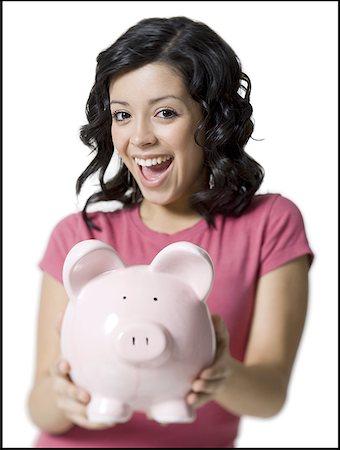 piggy bank hand - Portrait of a teenage girl holding a piggy bank Stock Photo - Premium Royalty-Free, Code: 640-01349099