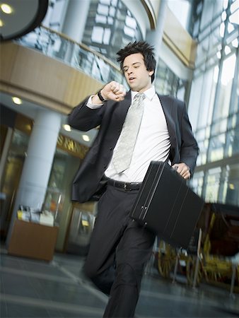 Businessman checking the time Stock Photo - Premium Royalty-Free, Code: 640-01349201