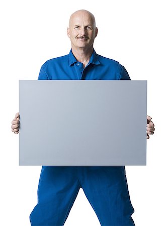 picture of a plumber - Portrait of a man holding up a blank sign Stock Photo - Premium Royalty-Free, Code: 640-01349217