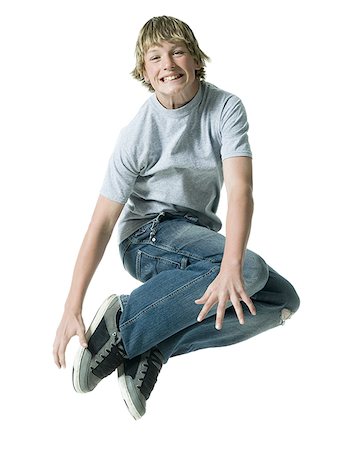 Portrait of a teenage boy jumping in mid air Stock Photo - Premium Royalty-Free, Code: 640-01349297