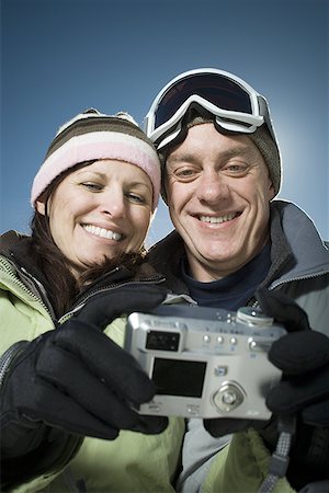 simsearch:628-01712405,k - Low angle view of an adult couple looking at a digital camera Stock Photo - Premium Royalty-Free, Code: 640-01349360