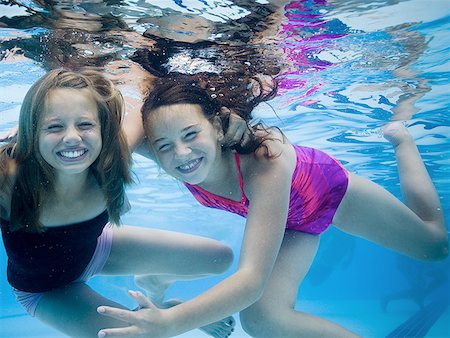 family underwater in a pool - Girls swimming underwater in pool Stock Photo - Premium Royalty-Free, Code: 640-01349431