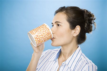 Close-up of a young woman drinking coffee Stock Photo - Premium Royalty-Free, Code: 640-01349470