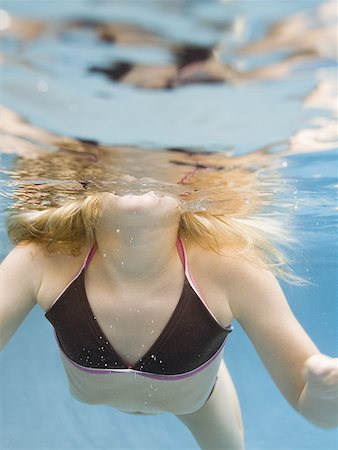 preteen models in bathing suits - Low angle view of a girl swimming Stock Photo - Premium Royalty-Free, Code: 640-01349471