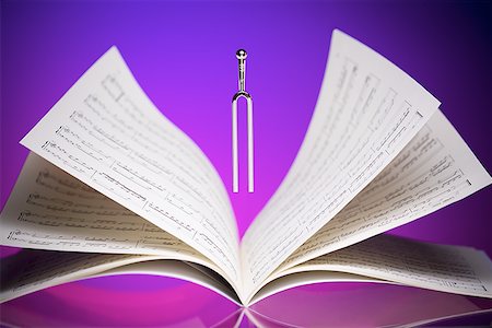 Close-up of a tuning fork and music sheets Stock Photo - Premium Royalty-Free, Code: 640-01349511