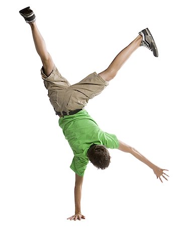 Rear view of a boy doing a handstand Stock Photo - Premium Royalty-Free, Code: 640-01349523