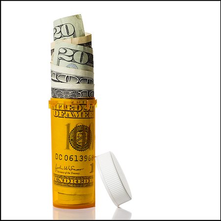 Prescription bottle filled with US currency Stock Photo - Premium Royalty-Free, Code: 640-01349549