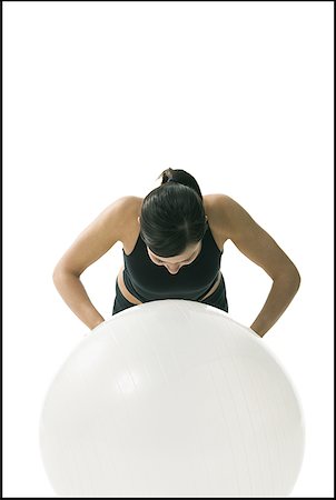 simsearch:640-01359251,k - Gros plan d'une femme exerçant sur un ballon de fitness Photographie de stock - Premium Libres de Droits, Code: 640-01349651