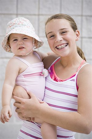 sister hugs baby - Girl holding baby Stock Photo - Premium Royalty-Free, Code: 640-01349653