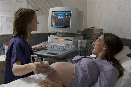 pediatric happy - Female doctor performing an ultrasound on a pregnant woman Stock Photo - Premium Royalty-Free, Code: 640-01349671