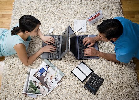 simsearch:640-05761336,k - High angle view of a mid adult woman and a mature man working on laptops Foto de stock - Sin royalties Premium, Código: 640-01349758