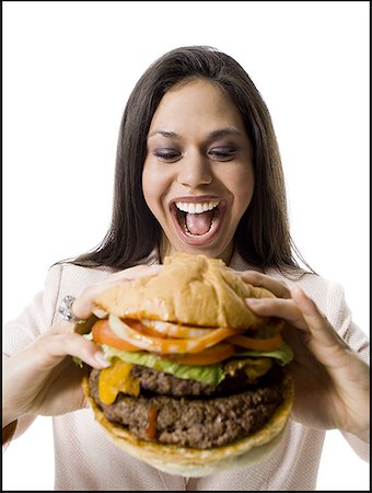 Close-up of a young woman holding a hamburger Foto de stock - Sin royalties Premium, Código: 640-01349773