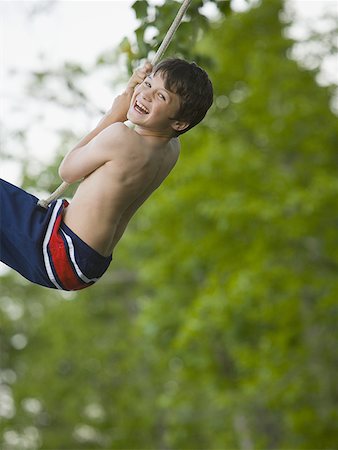 fluttuazione - Portrait of a boy swinging on a rope Fotografie stock - Premium Royalty-Free, Codice: 640-01349959