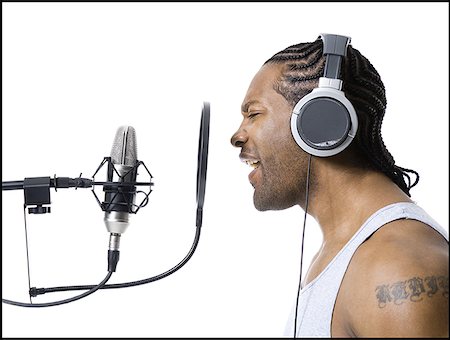 rap - African American man singing into microphone Fotografie stock - Premium Royalty-Free, Codice: 640-01349952