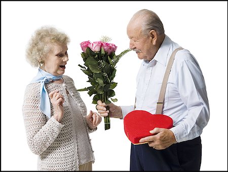 Older man giving wife Valentines chocolate Stock Photo - Premium Royalty-Free, Code: 640-01349962
