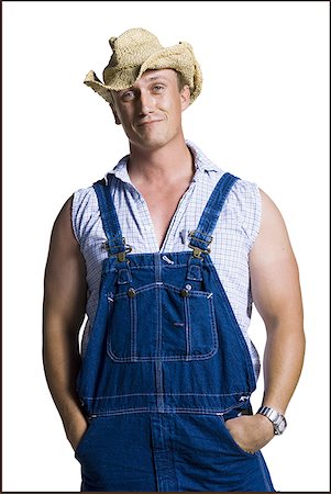 farmer wear overall - Farmer wearing a straw hat with hands in pockets Stock Photo - Premium Royalty-Free, Code: 640-01354144