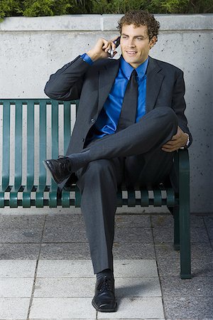 simsearch:640-01362708,k - Businessman sitting on a bench, talking on a mobile phone Stock Photo - Premium Royalty-Free, Code: 640-01354145