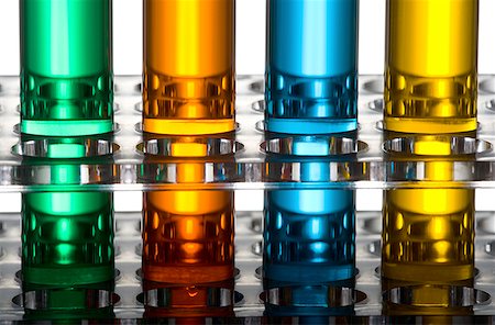 Close-up of four test tubes on a test tube rack Stock Photo - Premium Royalty-Free, Code: 640-01354177