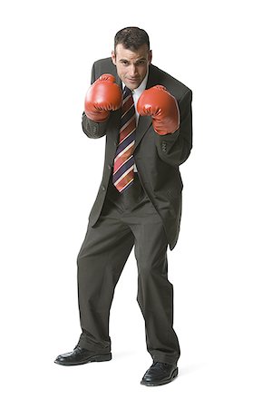 Portrait of a businessman wearing boxing gloves Stock Photo - Premium Royalty-Free, Code: 640-01354200