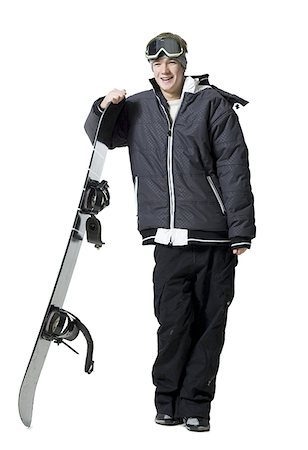 smile snowboard - Teenage boy standing with snowboard and goggles Stock Photo - Premium Royalty-Free, Code: 640-01354202