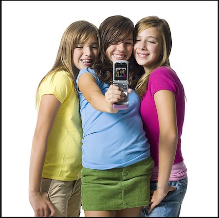 Three girls with camera phone Stock Photo - Premium Royalty-Free, Code: 640-01354275