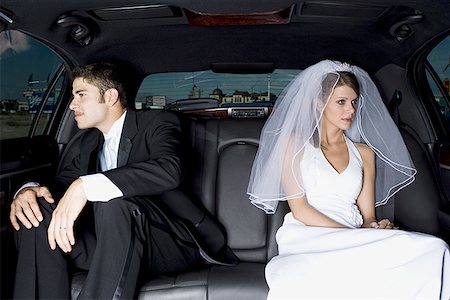 Close-up of a newlywed couple sitting in a car Stock Photo - Premium Royalty-Free, Code: 640-01354273