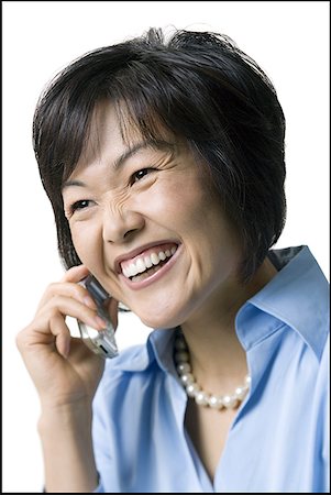 Woman talking on wireless phone, smiling. Stock Photo - Premium Royalty-Free, Code: 640-01354286