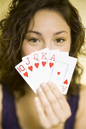 poker and smile - Teenage girl playing poker holding straight flush Stock Photo - Premium Royalty-Free, Code: 640-01354289