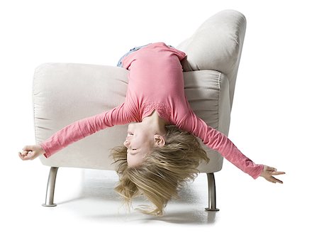 Girl lying upside down on a couch Stock Photo - Premium Royalty-Free, Code: 640-01354313