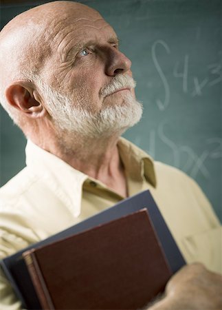 professor at chalkboard - Close-up of a senior male professor carrying diaries Stock Photo - Premium Royalty-Free, Code: 640-01354347