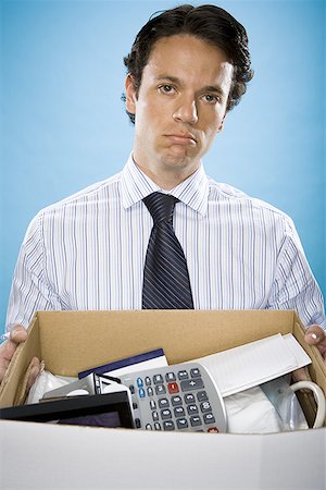 distressed background - Portrait of a businessman holding a cardboard box full of belongings Stock Photo - Premium Royalty-Free, Code: 640-01354378