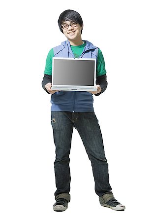 simsearch:640-01355807,k - Man with eyeglasses holding laptop to camera smiling Stock Photo - Premium Royalty-Free, Code: 640-01354372