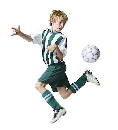 Young boy kicking a soccer ball Foto de stock - Sin royalties Premium, Código: 640-01354514