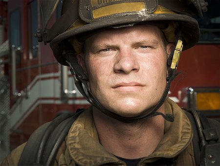 firemen uniform - Portrait of a firefighter wearing a helmet Stock Photo - Premium Royalty-Free, Code: 640-01354538