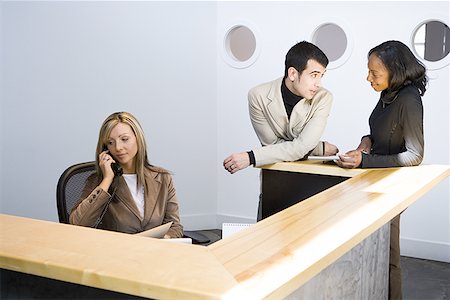 Two businesswomen and a businessman in an office Stock Photo - Premium Royalty-Free, Code: 640-01354656