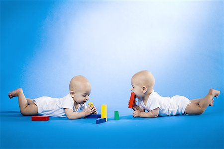 simsearch:640-01351279,k - Twin babies on bellies with blocks Stock Photo - Premium Royalty-Free, Code: 640-01354711