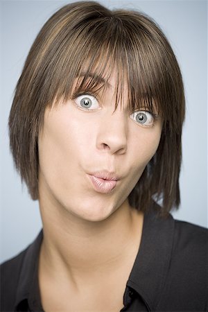 Portrait of a teenage girl making a face Stock Photo - Premium Royalty-Free, Code: 640-01354742