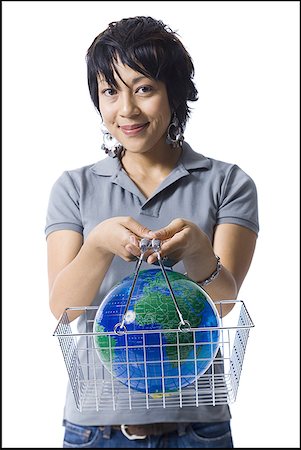 Woman holding shopping basket with globe Stock Photo - Premium Royalty-Free, Code: 640-01354765