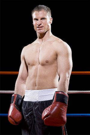 Portrait of a young man standing in a boxing ring Stock Photo - Premium Royalty-Free, Code: 640-01354832