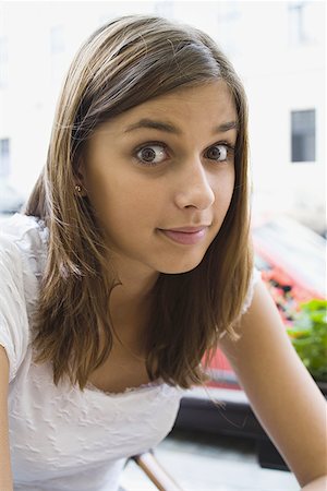 simsearch:400-04889881,k - Portrait of a young woman sitting outdoors Stock Photo - Premium Royalty-Free, Code: 640-01354847