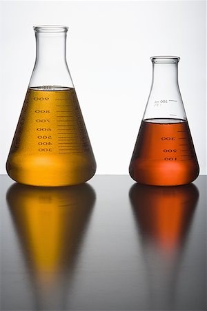 Close-up of two liquid filled flasks Stock Photo - Premium Royalty-Free, Code: 640-01354882