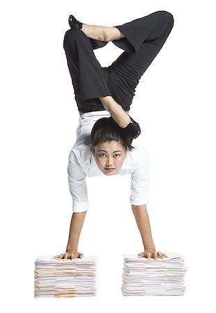 paper stack on white background - Female contortionist businesswoman Stock Photo - Premium Royalty-Free, Code: 640-01354915