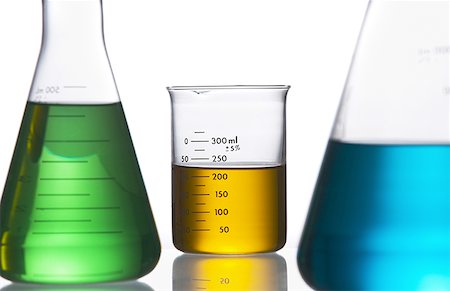 Close-up of beakers on a table in a laboratory with colored liquid Stock Photo - Premium Royalty-Free, Code: 640-01355036