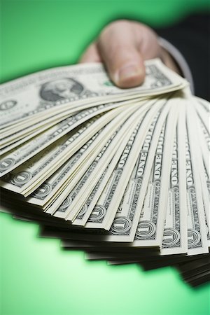 Close-up of a person's hand holding paper currency Foto de stock - Sin royalties Premium, Código: 640-01355030