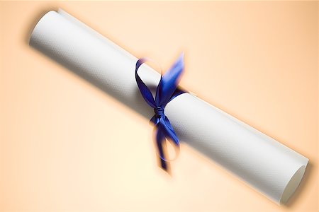 rolled up paper - Close-up of a ribbon on a scroll Stock Photo - Premium Royalty-Free, Code: 640-01355074