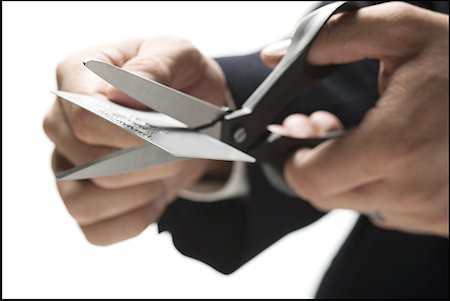 simsearch:640-01359139,k - Close-up of a person's hand cutting a credit card with a pair of scissors Foto de stock - Sin royalties Premium, Código: 640-01355114
