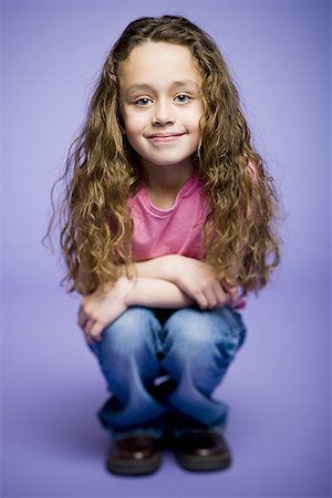 smirk girl - Portrait of a girl crouching Stock Photo - Premium Royalty-Free, Code: 640-01355156