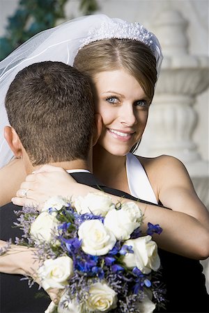 Portrait of a newlywed couple embracing Stock Photo - Premium Royalty-Free, Code: 640-01355191